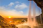 Iceland, Seljalandsfoss at sunset, waterfall and sun