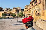 India, Rajasthan, Jaipur, Amer.  The main courtyard of the magnificent 16th century Amber Fort with a turbaned mahout in the foreground.