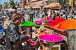 India, Rajasthan, Jaipur.  Coloured powders for the annual Hindu religious festival of Holi being sold from a mobile stall in the busy market area of old Jaipur.