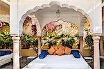 India, Rajasthan, Jaipur.  An attractive poolside alcove at the Samode Haveli, a historic 175 years old mansion which has been converted into a luxury hotel.