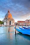 Italy, Veneto, Venice. Gondolas moored on the Gran Canal overlooking Santa Maria della Salute.
