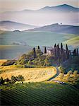 Val d'Orcia, Tuscany, Italy. A lonely farmhouse with cypress and olive trees, rolling hills.