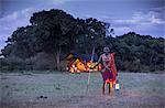Kenya, Mara North Conservancy. An askari guide ready to escort his guests to their tent at Elephant Pepper Camp.