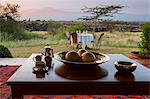 Kenya, Amboseli, Tortilis Camp. A table set for breakfast outside the private house in Tortilis.