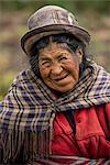 South America, Peru, Puno,  Lake Titicaca, old woman harvesting potatoes