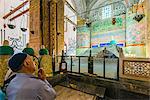 Worshiper praying on Mevlana s Tomb at Mevlana Museum, Konya, Turkey