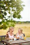 Mother and daughter having meal outdoor