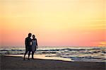 Couple on beach at sunset