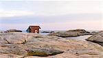 Wooden shed on rocky coast