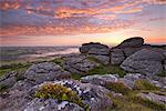 Spectacular sunrise in summer above the granite tor on Meldon Hill, Dartmoor National Park, Devon, England, United Kingdom, Europe