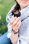 A woman eating a ripe fig.