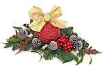 Christmas decoration with red bauble, holly, mistletoe, ivy and winter greenery over white background.