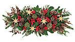 Christmas gold star decorations, holly, mistletoe, ivy, pine cones and traditional greenery over white background.