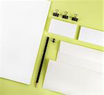 Photo of blank stationery set on green background. Template for branding identity. Top view.
