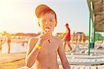 Baby boy with ice-cream at the beach