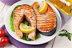 Grilled salmon and white wine on wooden table