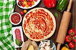 Pizza cooking ingredients. Dough, vegetables and spices. Top view