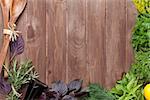 Fresh garden herbs over wooden table. Top view with copy space