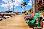 Brightly colored adirondack chairs on a dock at Bitter End Yacht Club on Virgin Gorda Island, BVI