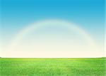 Green grass field and deep blue sky with rainbow background