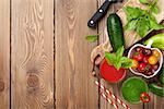Fresh vegetable smoothie on wooden table. Tomato, cucumber, pepper. Top view with copy space