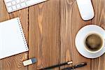 Office desk table with computer, supplies and coffee cup. Top view with copy space