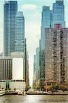 An image of some high rise buildings in New York with an advertising wall