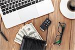 Office table with pc, coffee cup, glasses and money cash. View from above