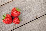 Ripe strawberries over wooden table background with copy space