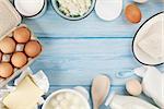 Dairy products on wooden table. Sour cream, milk, cheese, egg, yogurt and butter. Top view with copy space