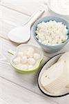 Dairy products on wooden table. Sour cream, milk and cheese. Top view