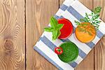 Fresh vegetable smoothie on wooden table. Tomato, cucumber, carrot. Top view with copy space