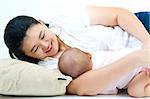 Asian mother breastfeeding her baby girl
