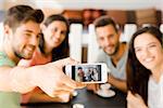 Group of friends at the coffee shop making a selfie together