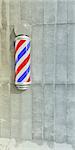 barber pole on concrete wall