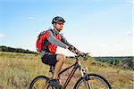 Cyclist Riding the Bike on the Beautiful Summer Mountain Trail. Sport Lifestyle Concept.