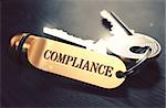 Keys with Word Compliance on Golden Label over Black Wooden Background. Closeup View, Selective Focus, 3D Render. Toned Image.