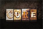 The word "CURE" written in rusty metal letterpress type on a dark grunge background.