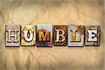 The word "HUMBLE" written in rusty metal letterpress type on a crumbled aged paper background.