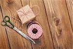 Gift wrapping with boxes and scissors over wooden table