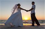 A married couple, bride and groom, sunset sunrise wedding on a beautiful tropical beach