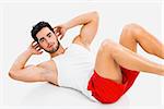 Athletic young man doing ABS, isolated over a gray background