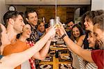 Group of friends toasting and looking happy at a restaurant