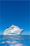 A white cruise ship in front of the clear blue sky