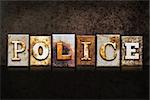 The word "POLICE" written in rusty metal letterpress type on a dark textured grunge background.