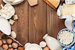 Dairy products on wooden table. Milk, cheese, egg, curd cheese and butter. Top view with copy space
