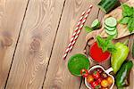 Fresh vegetable smoothie on wooden table. Tomato and cucumber. Top view with copy space