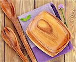 Wooden kitchen utensils over wood table