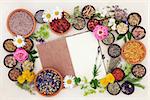 Health care using herbal medicine flower and herb selection with hemp notebook over cream paper background.
