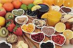 Super food selection for cold and flu remedy including foods high in vitamic c and antioxidants with herbal medicine and supplement capsules.